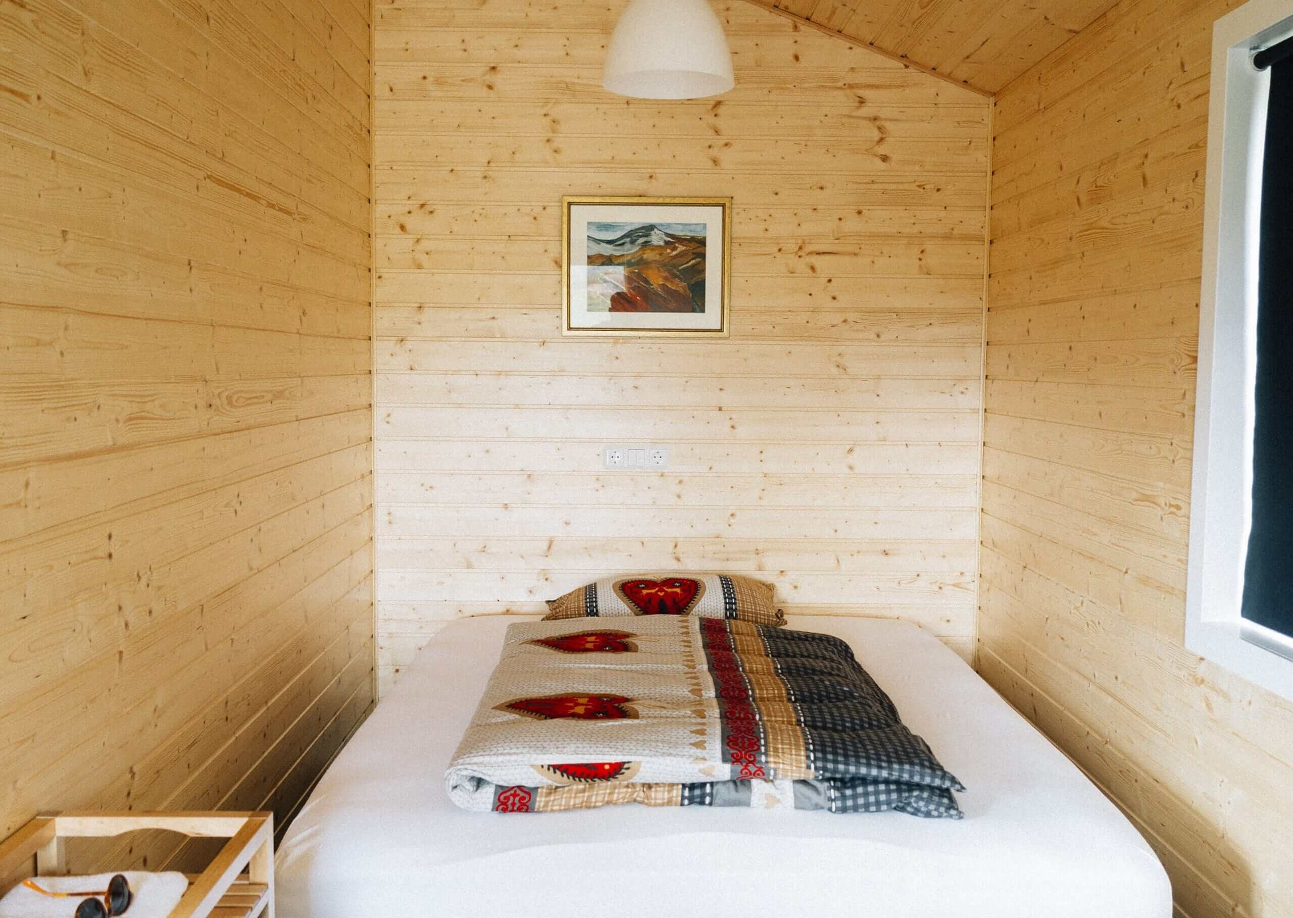 Small bedroom with wood panelled walls